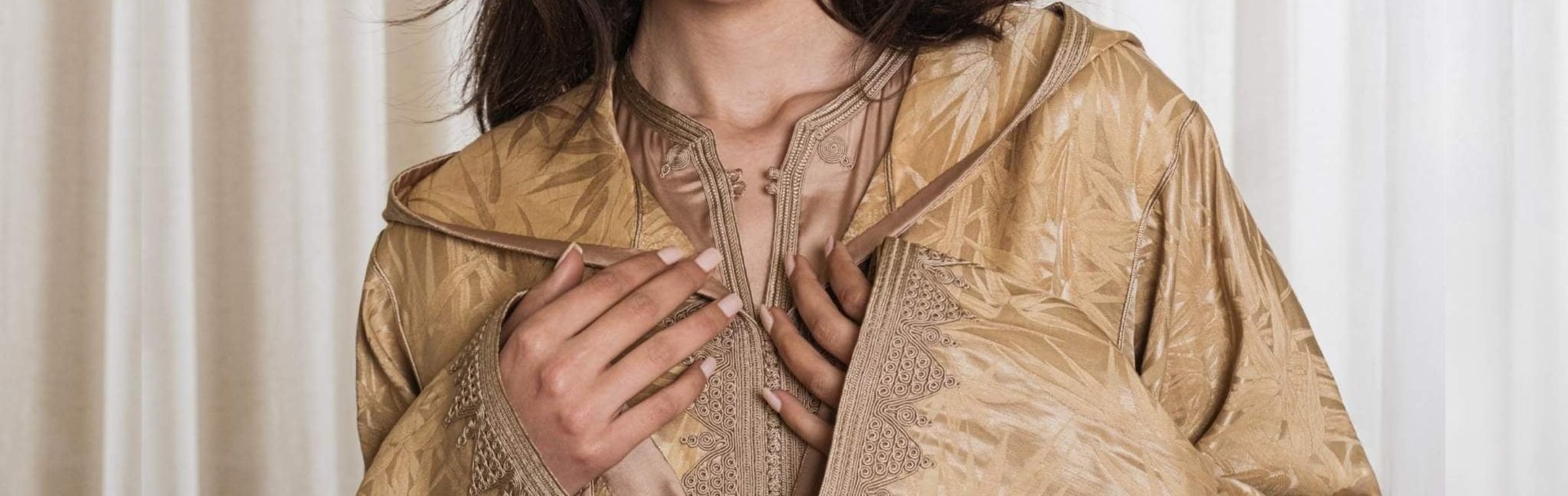 Gold jacquard hooded Moroccan djellaba, hand-embroidered placket seen close