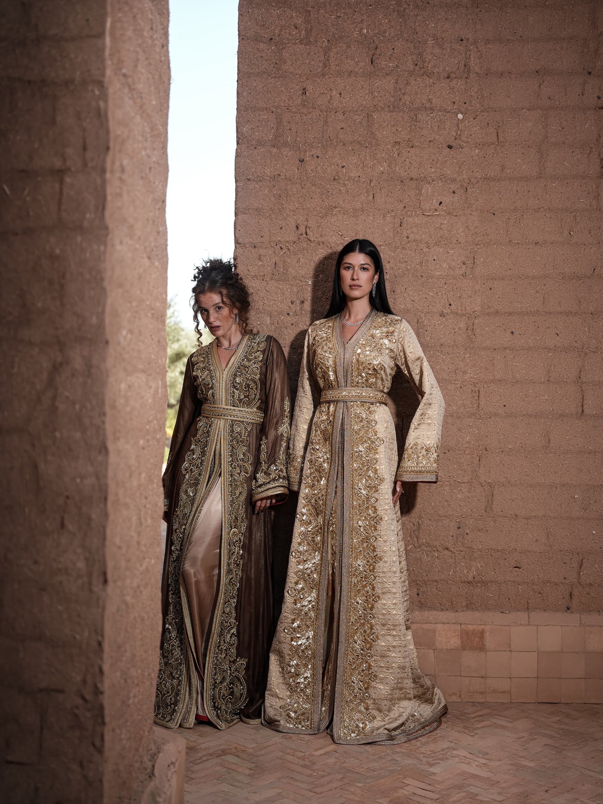 Alabaster Aria quilted ivory brocade Moroccan kaftan with gold sequin embroidery and belted waist, shown alongside a second look